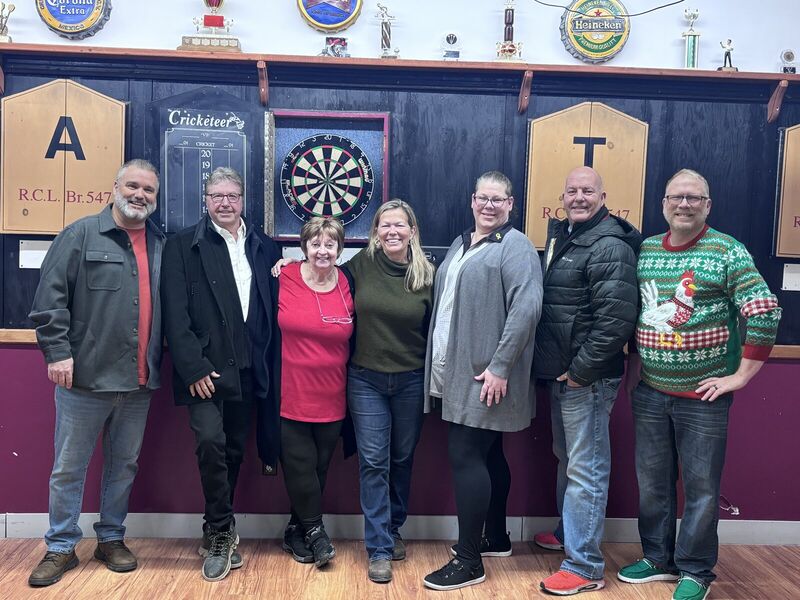 Group of friends in front of dart boards