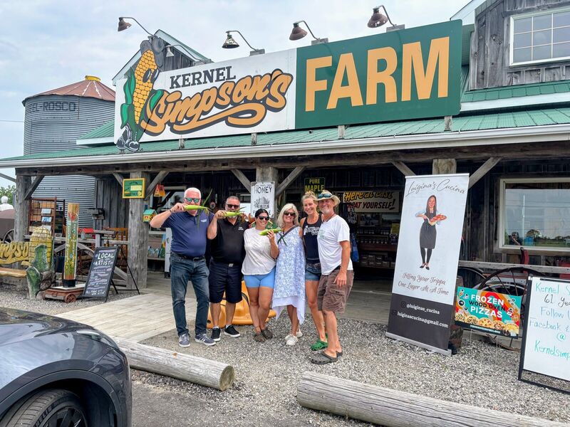 Group outside a farm market storefront